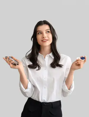 A smiling woman in a white shirt holding a pair of glasses and contact lenses