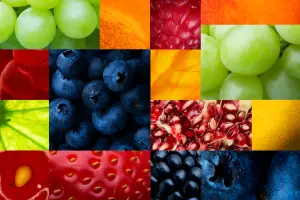 A collage of various fruits including blueberries, strawberries, raspberries, grapes, pomegranates, and kiwi.