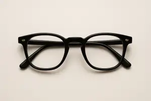 Black glasses with round lenses on a white background