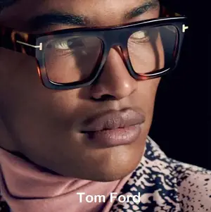 Tom Ford eyewear model wearing tortoise shell glasses with silver T logo