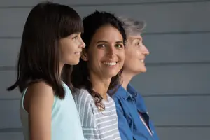 Three women standing next to each other and smiling at the camera