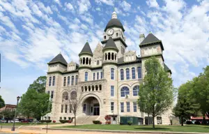 A building with a clock on the tower and many windows