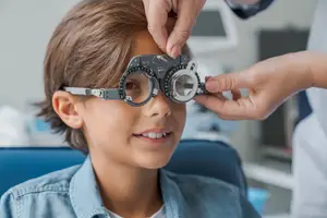 A child wearing trial lens prescription after having an eye exam