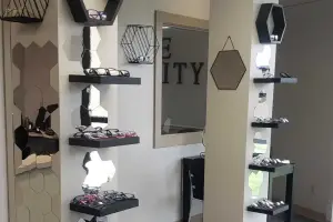Eyewear shop with a variety of frames on display against a backdrop of geometric mirrors and hexagon wall tiles