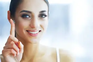 woman with hearing aid smiling