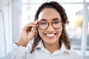 portrait of black woman with glasses for eye exam