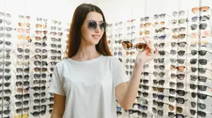 young woman at the optical store trying a new pair of sunglasses
