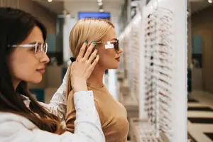 Two women trying on sunglasses in a store