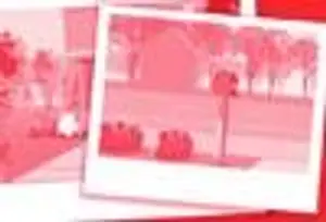 The image features a blurry photo with a red filter, showing a scene with people and a building. In the foreground, there are people standing near a building with a slanted roof, and there is a pole with a red object on it. The background is blurry, with trees and a road visible. The overall scene is illuminated by a red light, creating a warm and somewhat mysterious atmosphere.