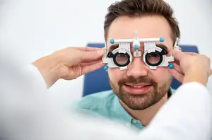 A male patient getting his eyes checked by an optometrist