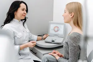 Woman at an eye doctor's office talking to the doctor