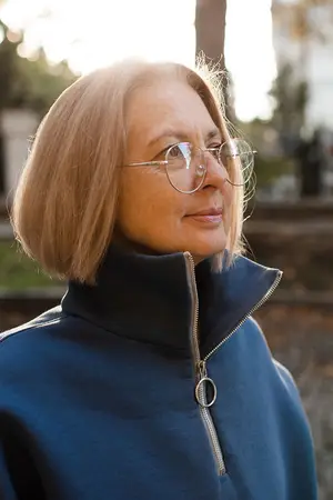 Woman with glasses standing in an outdoor area