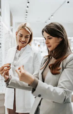 Two women in a store looking at glasses