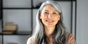 Portrait of a woman with gray hair and a smile