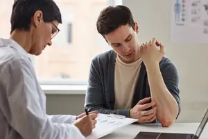 A doctor talks to a patient in a clinic
