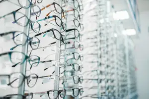 A wall of glasses frames displayed in a store.