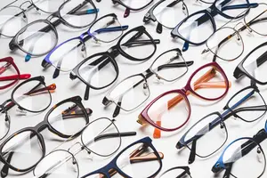 Multiple eyeglasses frames arranged on a white surface