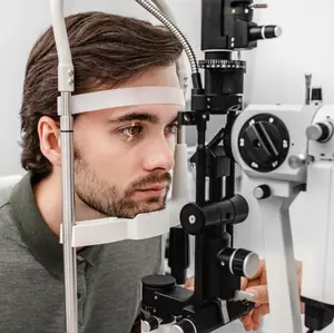 A man is having his eyes checked with an ophthalmoscope