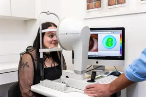 woman getting her eyes examined with an OCT device
