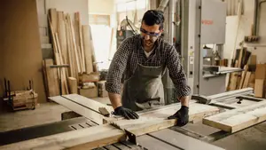A man working on a table saw in a workshop