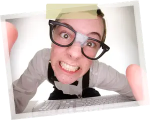 A man wearing glasses, a bow tie, and suspenders looks surprised while typing on a computer.