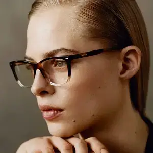 Close up of a woman wearing glasses looking at something off camera