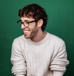 Man wearing fhone glasses and a white sweater