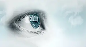 Close-up of a human eye with a blue iris and a futuristic-looking contact lens.