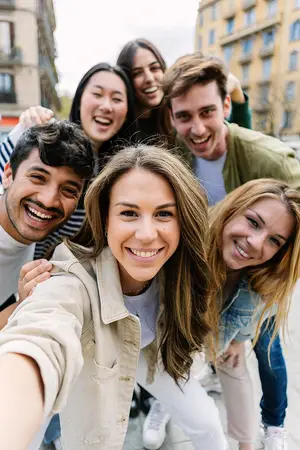 Group of people taking a selfie in front of a building