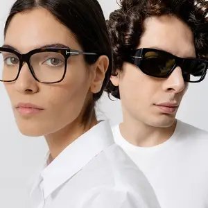 a man and woman posing in white shirts with glasses