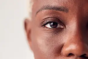 Close up of a woman's face with a focus on her eye and nose.