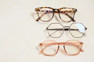 three pairs of glasses including one with a pearl on the end of the arm