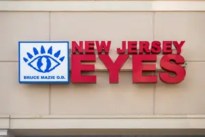 New Jersey Eyes logo on a building with a blue square featuring an eye icon and Bruce Mazie, O.D. text