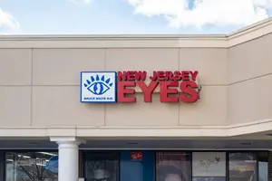 Exterior of a business called New Jersey Eyes with a sign with a red background and white and blue logo