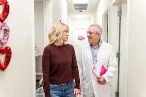 A doctor is speaking to a woman in a medical office.