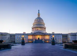 The Capitol building is brightly lit with many windows and a large dome on top