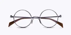 Pair of round-framed glasses with brown temples and silver frames against a white background