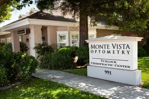 Monte Vista Optometry Turlock Chiropractic Center building with a white sign on the grass lawn