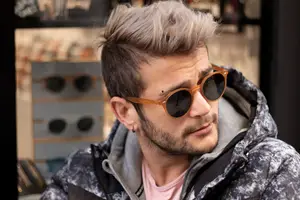 stylish young man modeling sunglasses rev