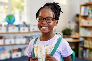 smiling school girl wearing eyeglasses