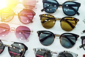 A collection of sunglasses with various lens colors and frame styles displayed on a white surface.
