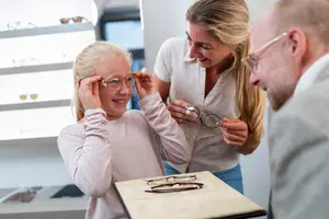 A family shopping for glasses at an optician's store.