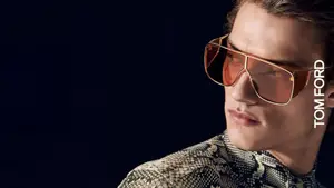 A man wearing Tom Ford sunglasses with a snake skin shirt