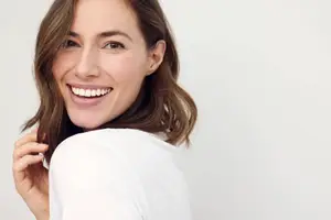 Woman looking over her shoulder and smiling