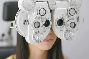 A woman is having her eyes examined with an optometrist's equipment