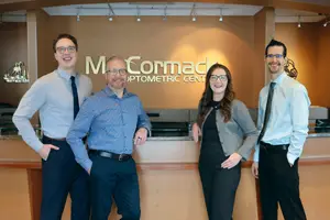 Four optometrists at McCormack Optometric Center smiling for a photo