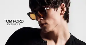 A man wearing Tom Ford Eyewear sunglasses is looking down.