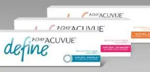 Three boxes of 1-Day Acuvue contact lenses are displayed on a gray background. The boxes are white with blue and pink accents and have the brand name '1-Day Acuvue' and the product type 'Define' written on them. The boxes are stacked on top of each other, and the front box has the text 'Natural Sparkle' on it. The image is likely an advertisement for the contact lenses.