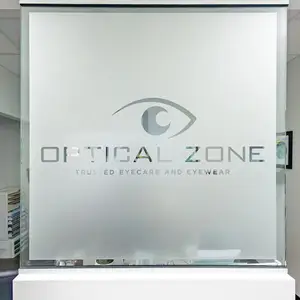 A glass sign with the text 'Optical Zone' and an eye logo is mounted on the wall.