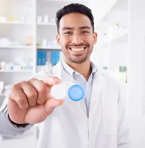 Male doctor holding a lens case in a pharmacy